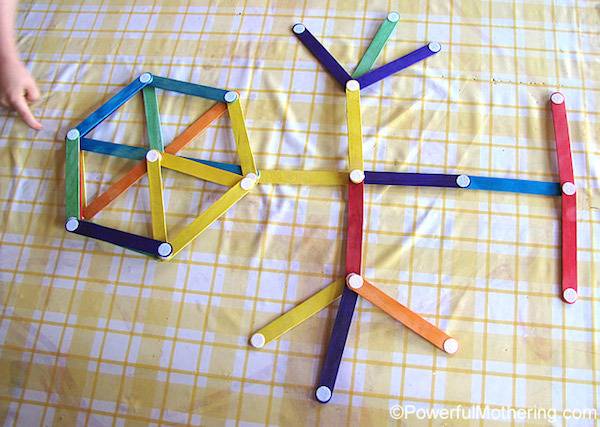 Several small & colorful wooden sticks are a part of an art piece.