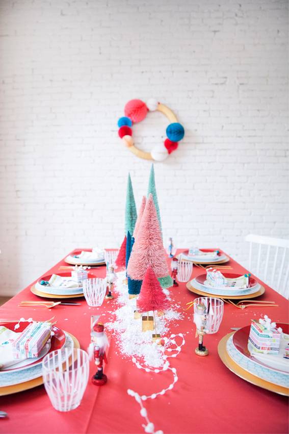 Red colored table set with Christmas decoration.
