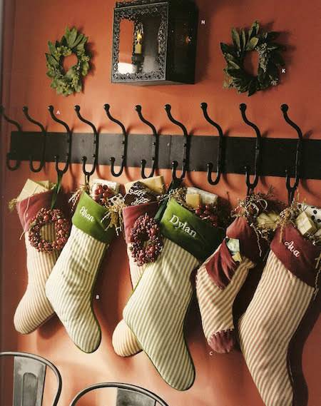 Christmas stockings hang on a wall.