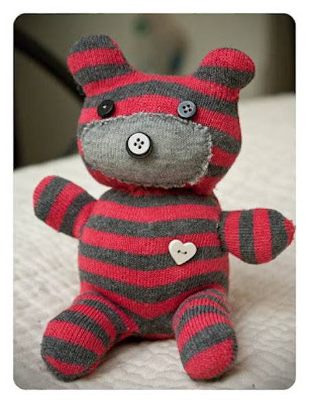 Small teddy with red and black bands.