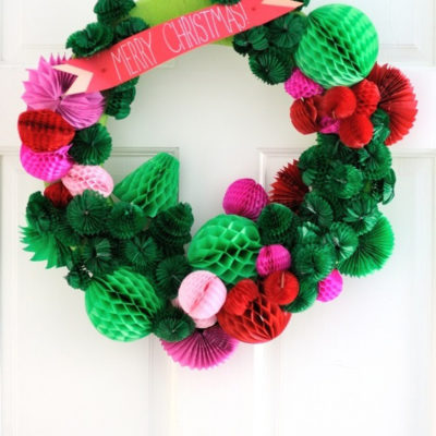 A green and red holiday wreath with ribbon.