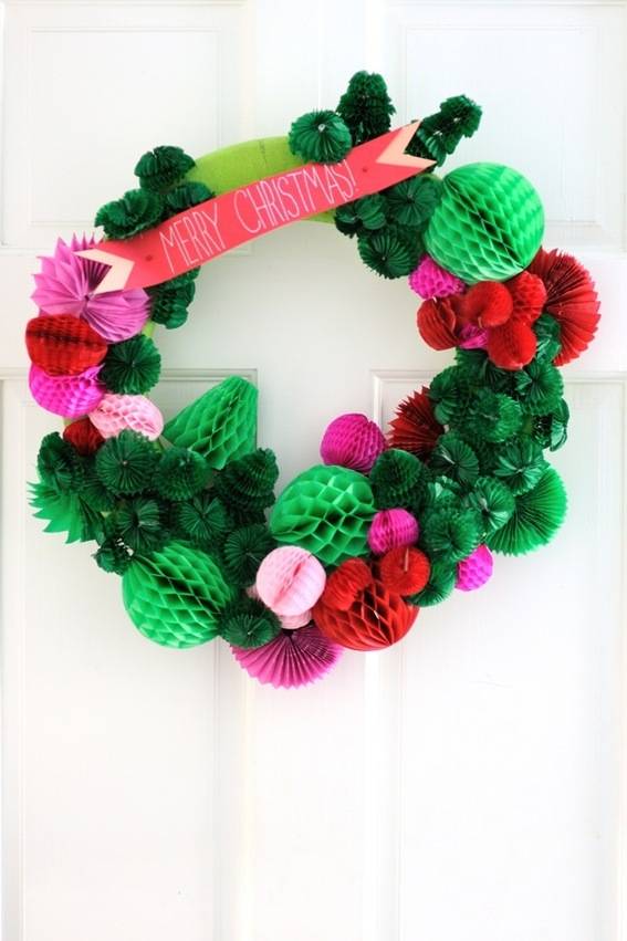 A green and pink wreath with fold out paper balls attached.