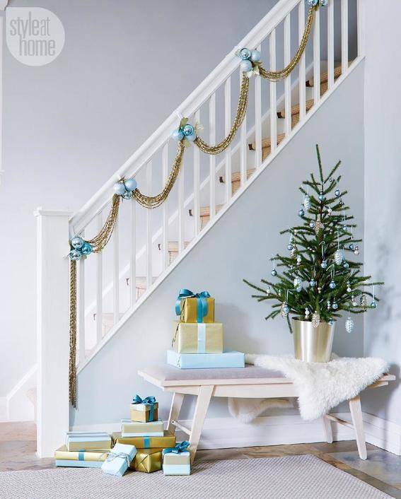 A white house with stairs decorated with Christmas theme