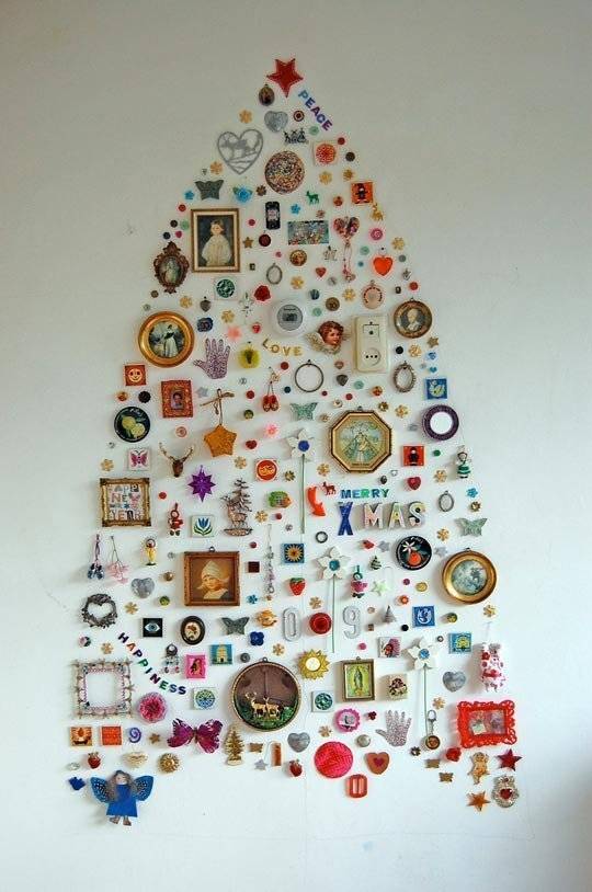 A bunch of items on a wall in the shape of a Christmas tree.