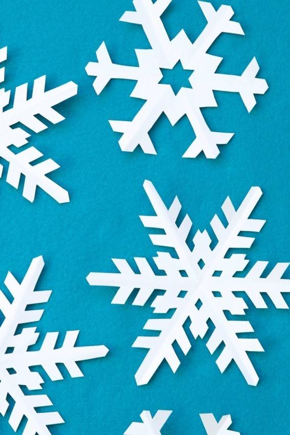 White paper snowflakes against a blue background.