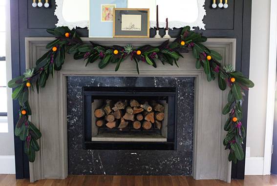 Wooden sticks on the fireplace is decorated with plastic leaves.