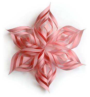 A pink flower is made from strips of paper.