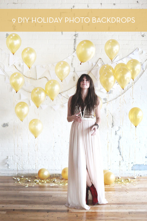 Woman posing for photo with gold colored balloons on the white background.
