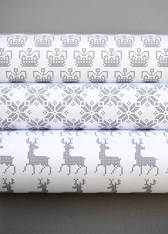 Three rolls of silver and white wrapping paper.