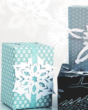 Gift boxes decorated with paper snowflakes.
