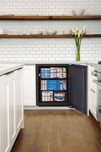 Home kitchen cabinet modified to fit small refrigerated items for additional storage.