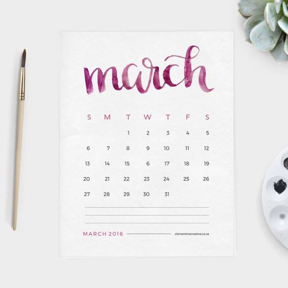 A pen is sitting next to a calendar with the month of March on it.