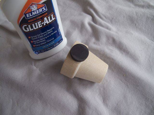 Glue all bottle and  a cup with button on top.