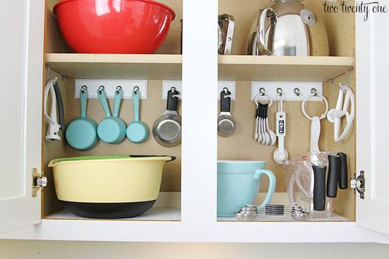 "Organized kitchen appliances with measurement cups and bowl."