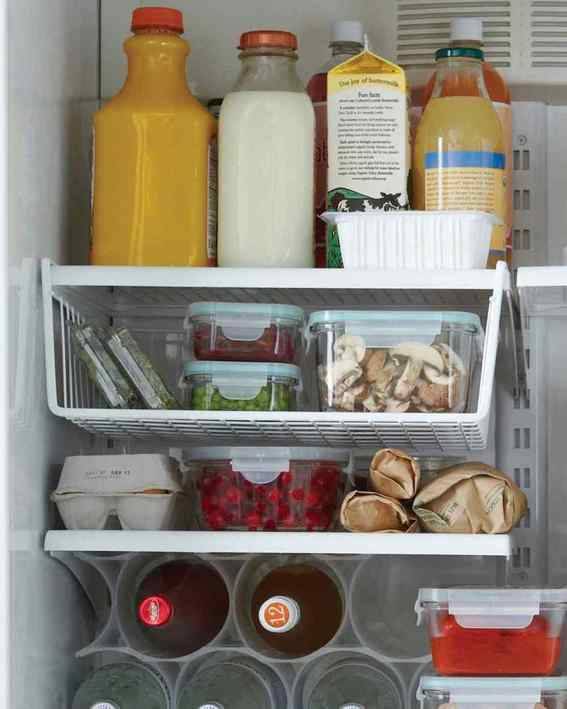 bottles with drinks and some groceries stored in refrigerator