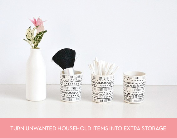 Cups and a bottle hold a flower and useful items.