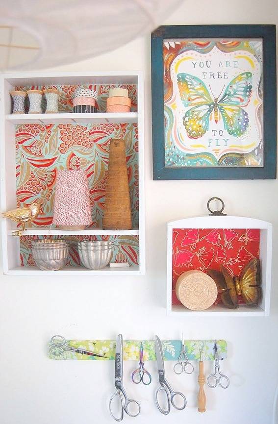 Pictures are hanging on a white wall.