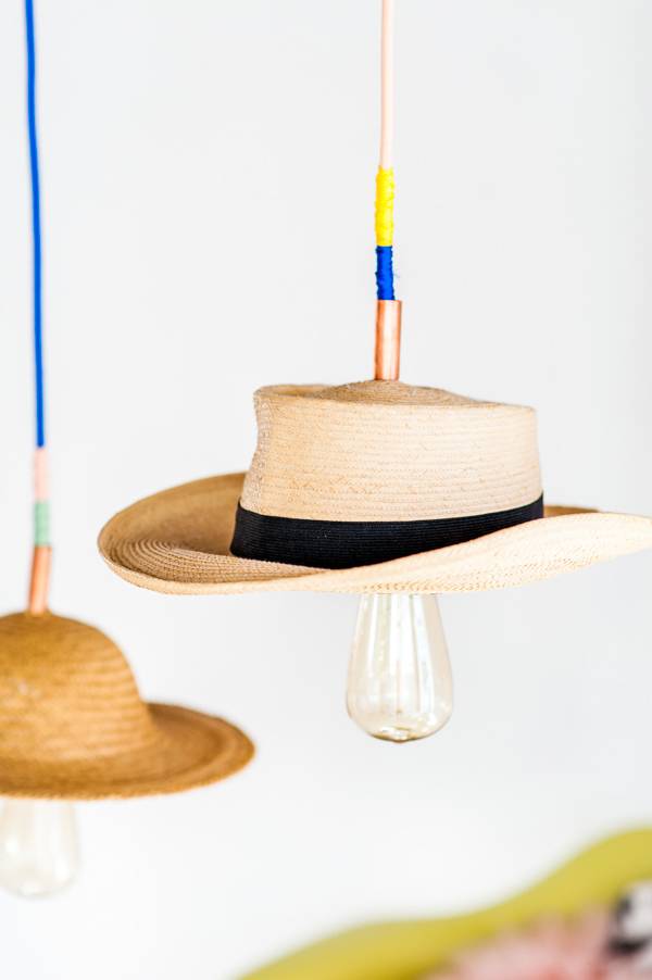 Two hanging lights with hats as shades.