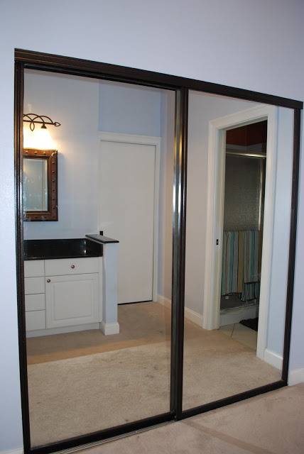 A washbasin visible through a glass gate in a room.