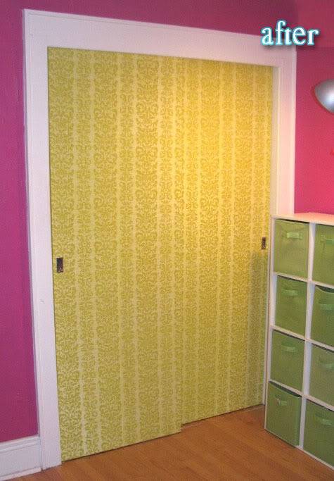 A yellow door with a white frame on a pink wall.