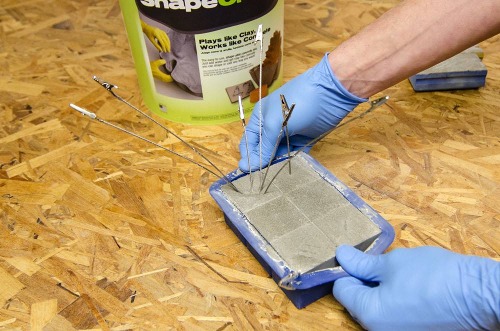 A person is preparing concrete using a box.