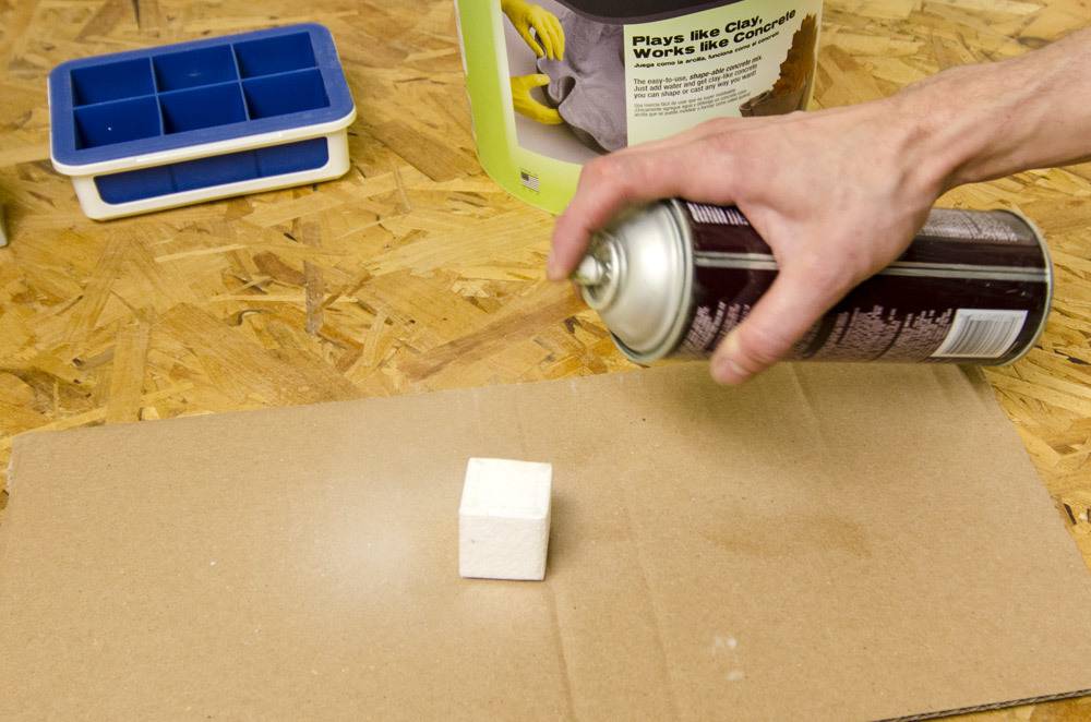 Spray one side of the styrofoam with adhesive