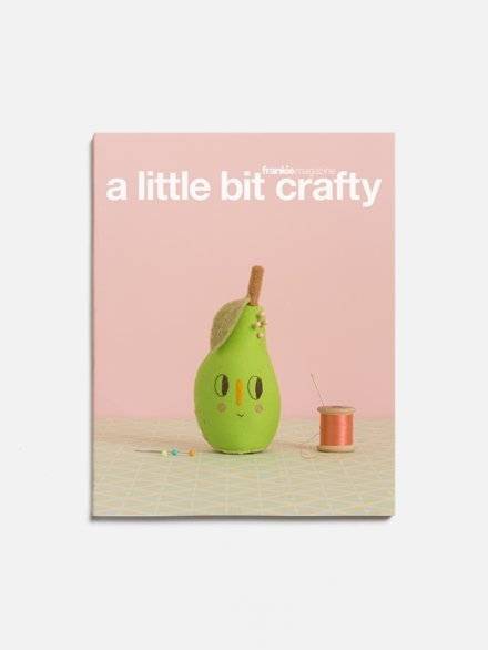 A pink book with a green bottle on the front that has a title that says, a little bit crafty.