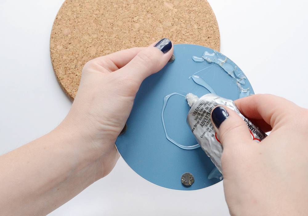 Use glue to secure mirror to cork board
