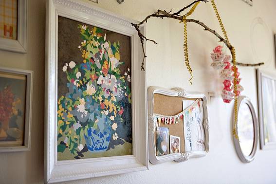 Pictures and decorations hang from a white wall.