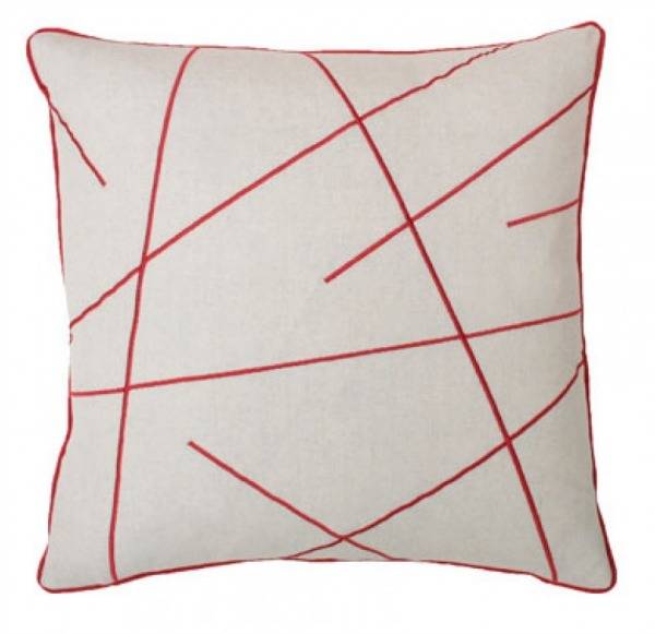 A square white pillow has thin red lines.