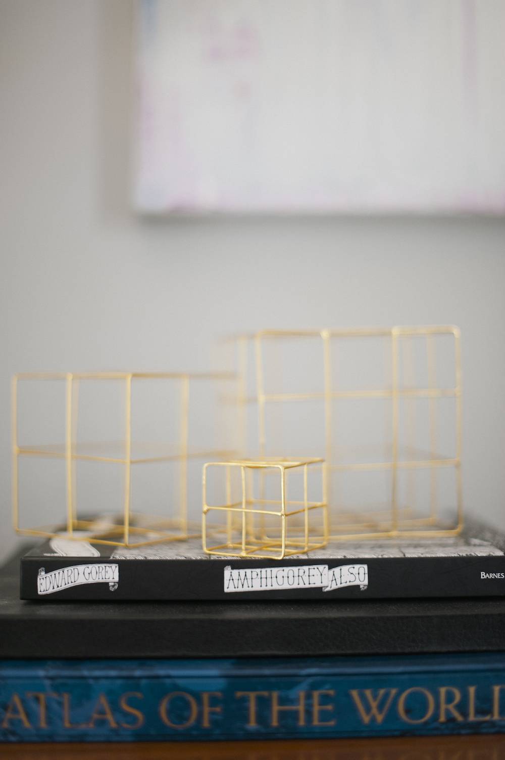 Three cubical frameworks of different sizes, made out of sticks which work as styling accessories.