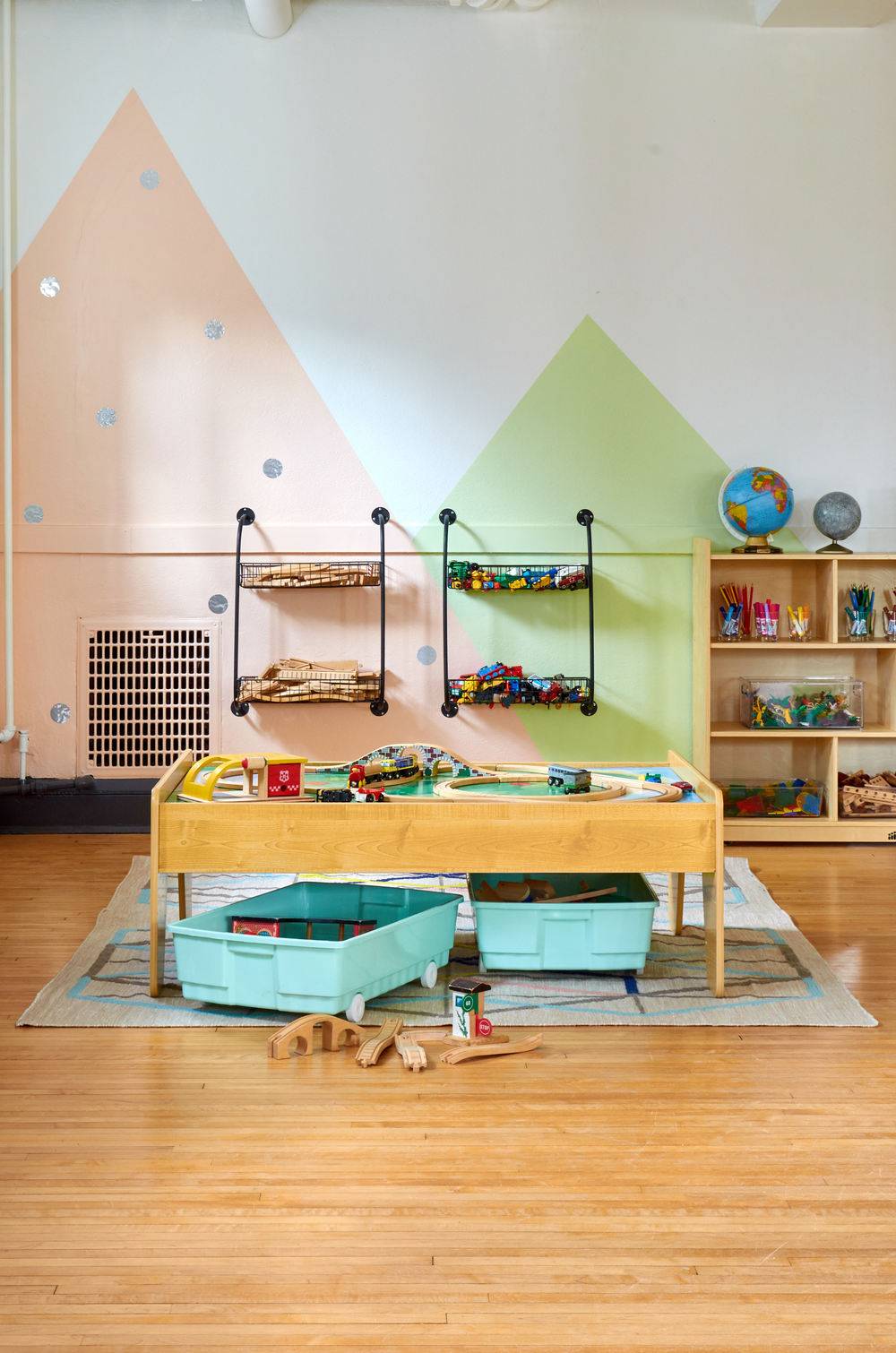 A nursery school with a game table and wall storage.