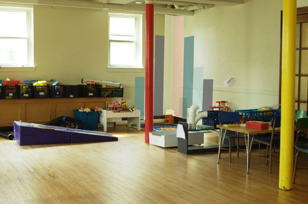 Colorful nursery school room with full of playing items and furniture.