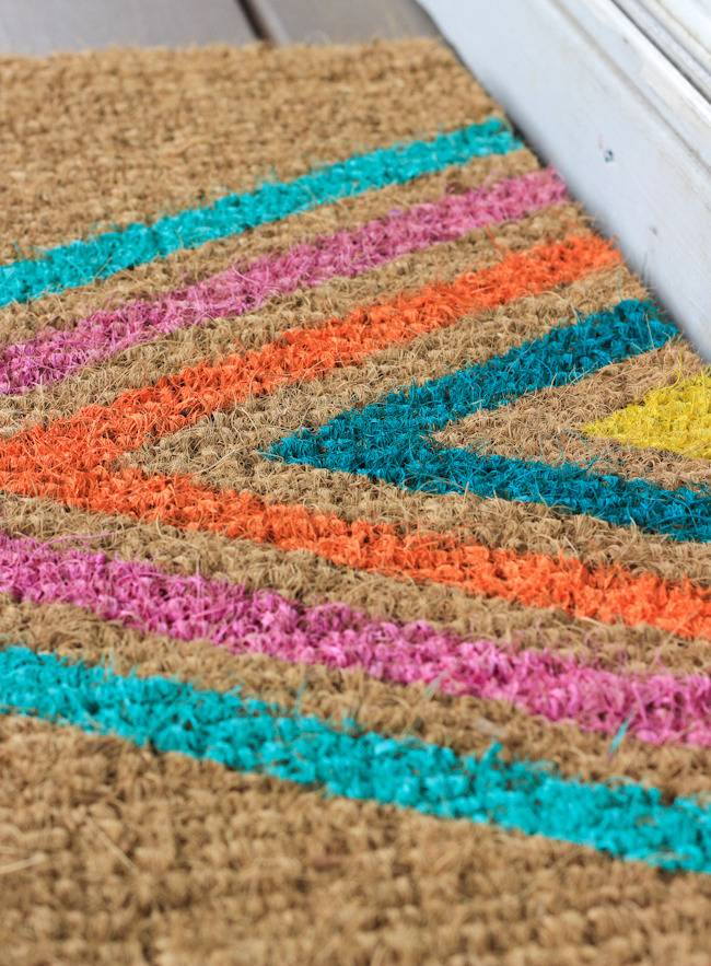 A floor mat with a colorful triangular design on it.