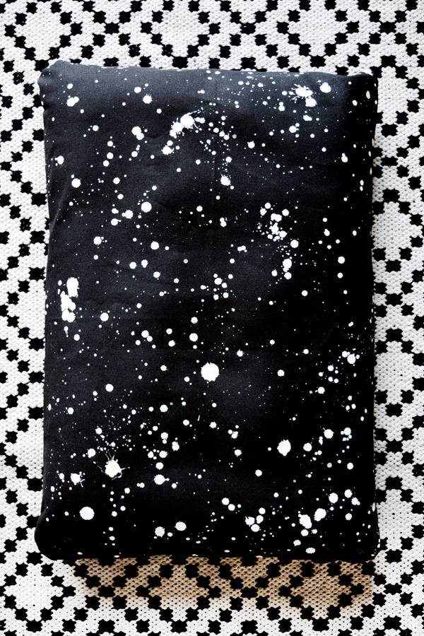Pet bed in black cloth with white dots.