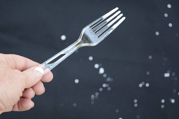 A person is holding a fork in his hand.