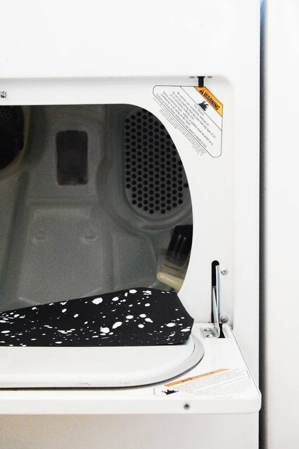 The door to a drying machine is open.