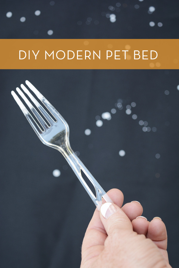 A person is holding a plastic fork in their hand.