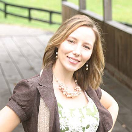 A brunette woman posing for a picture