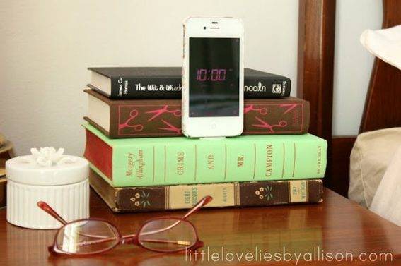 Books, mobile phone and specs on the table.