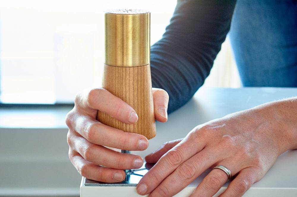 A person using a tool on a picture.