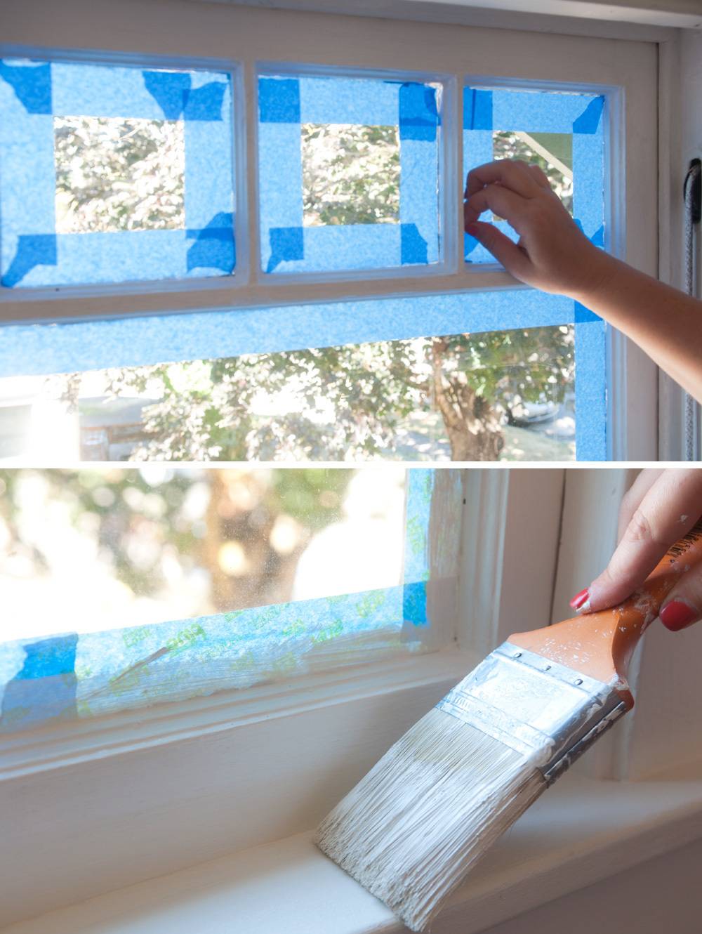 A person puts blue tape on a window to protect it.