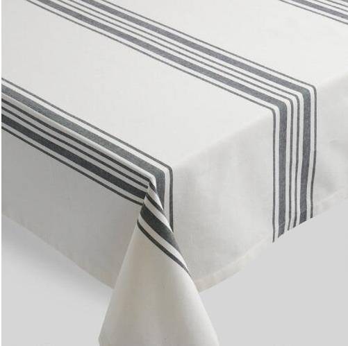 White and gray striped tablecloth on top of a table.