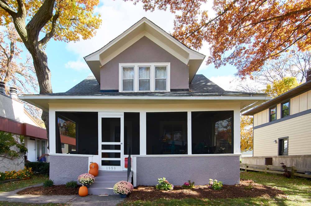 A screened porch on the front of a house.