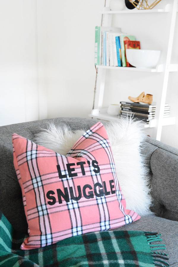 Pillow on sofa with words, "Let's Snuggle".