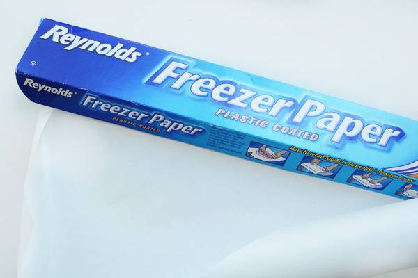 A blue box of freezer paper sits on a white surface.