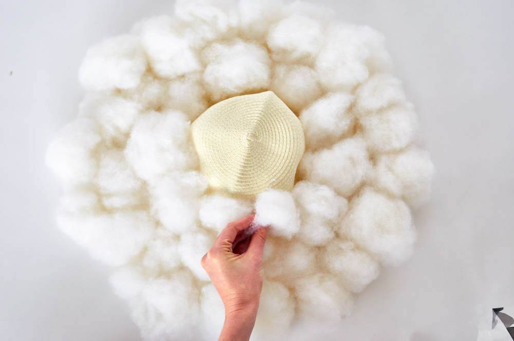 A person attaching cotton to something.
