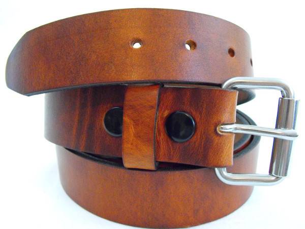 A rolled up brown belt with a plain silver buckle.