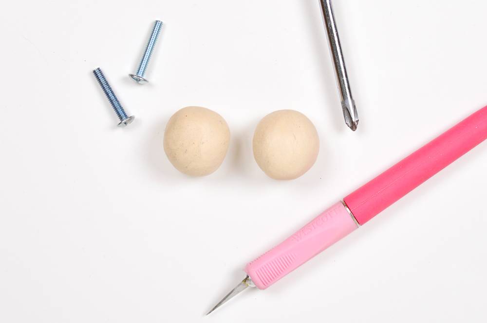 Tools sit on a surface near two beads.