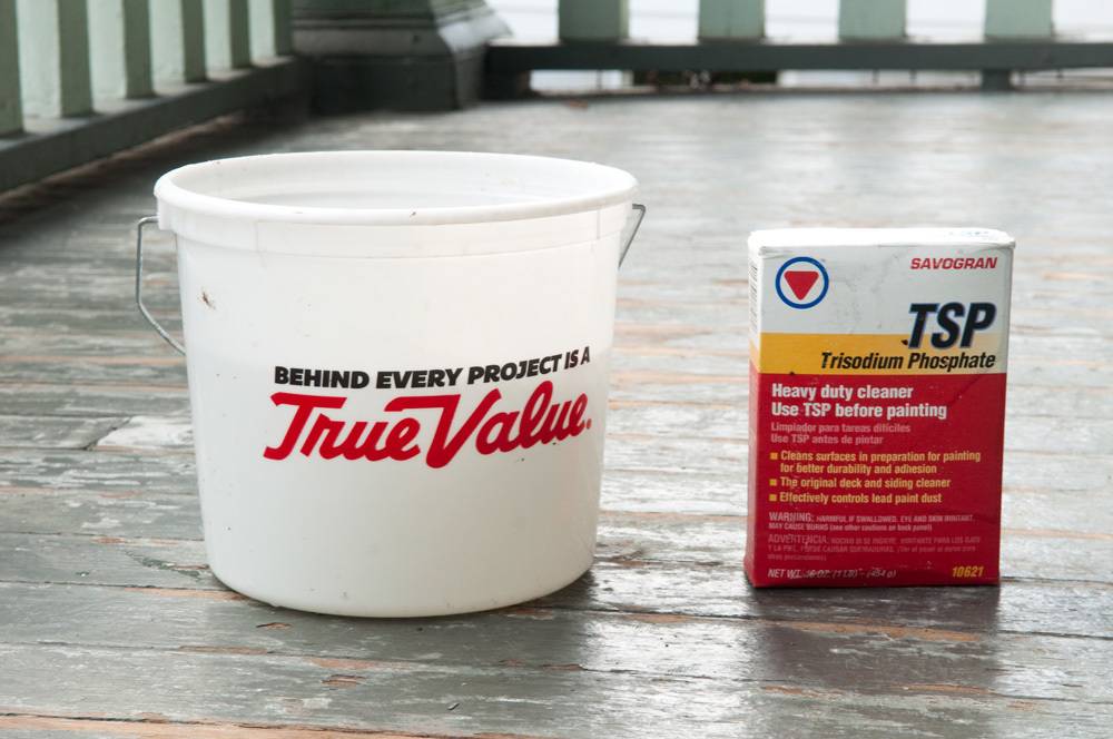 Bucket and TSP cleaner sitting on an old porch floor.
